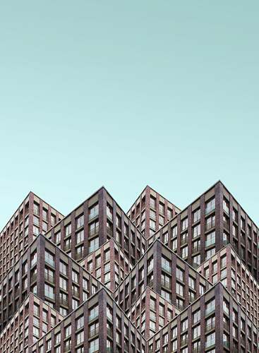 office building brown building under blue sky urban